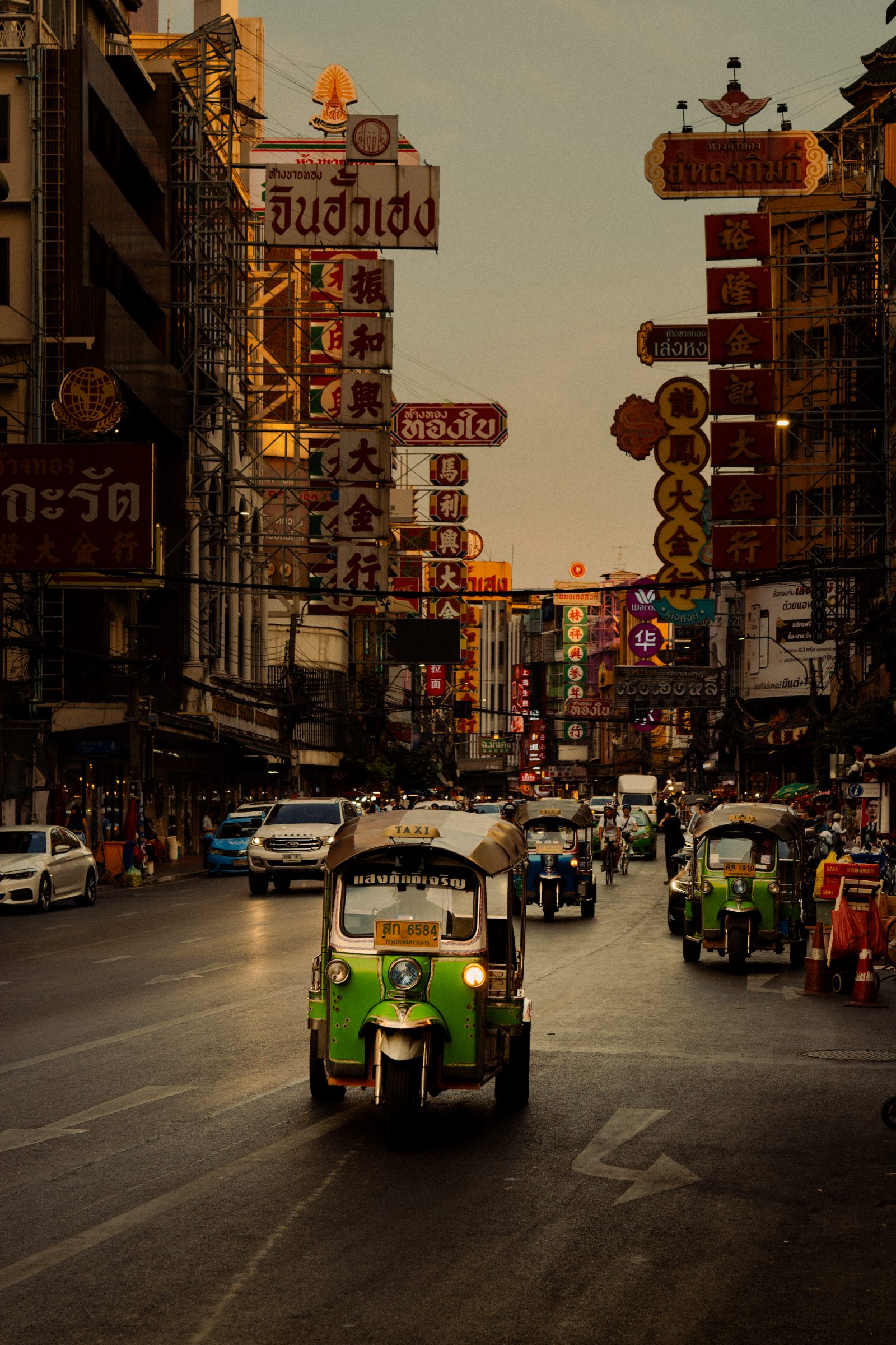 Tuk-tuks on a Bangkok street at dusk