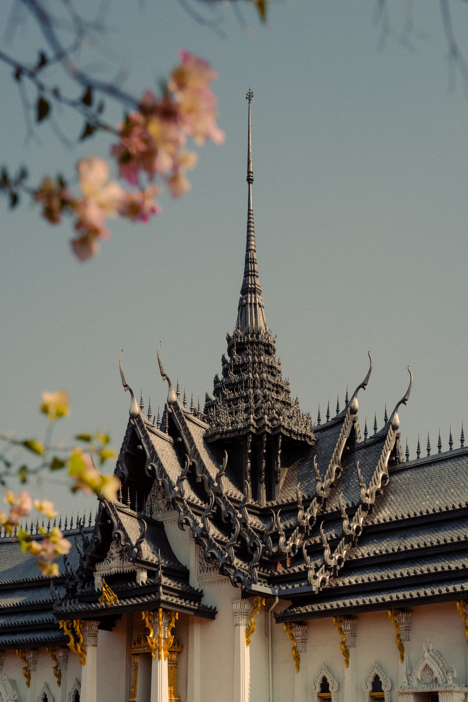 A Thai temple spire against blossom