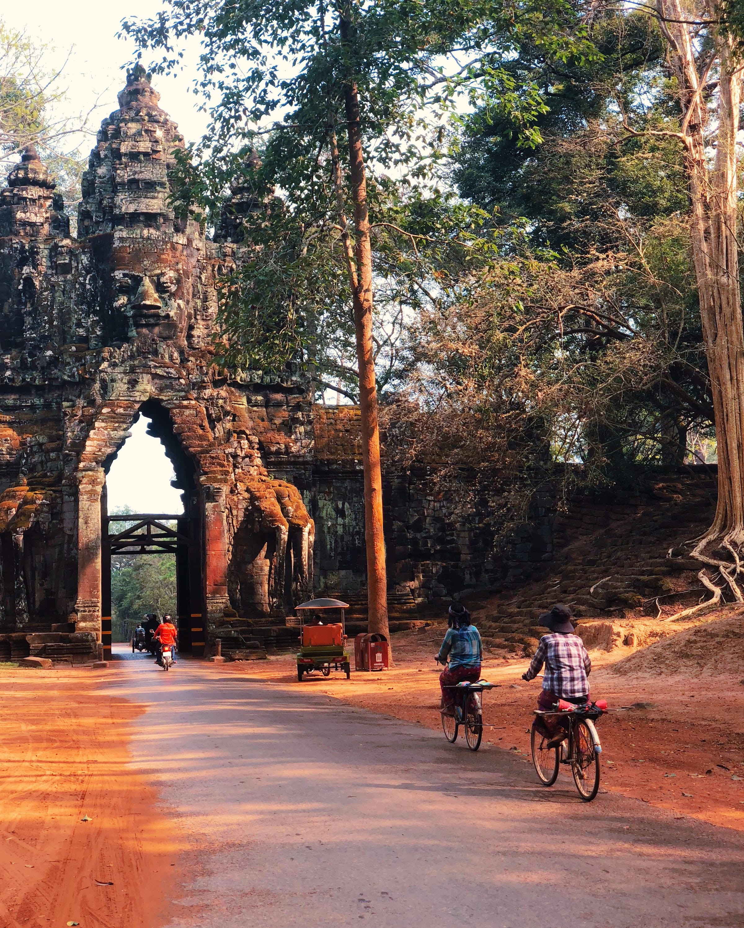 The south gate of Angkor Thom, cyclists on the red road