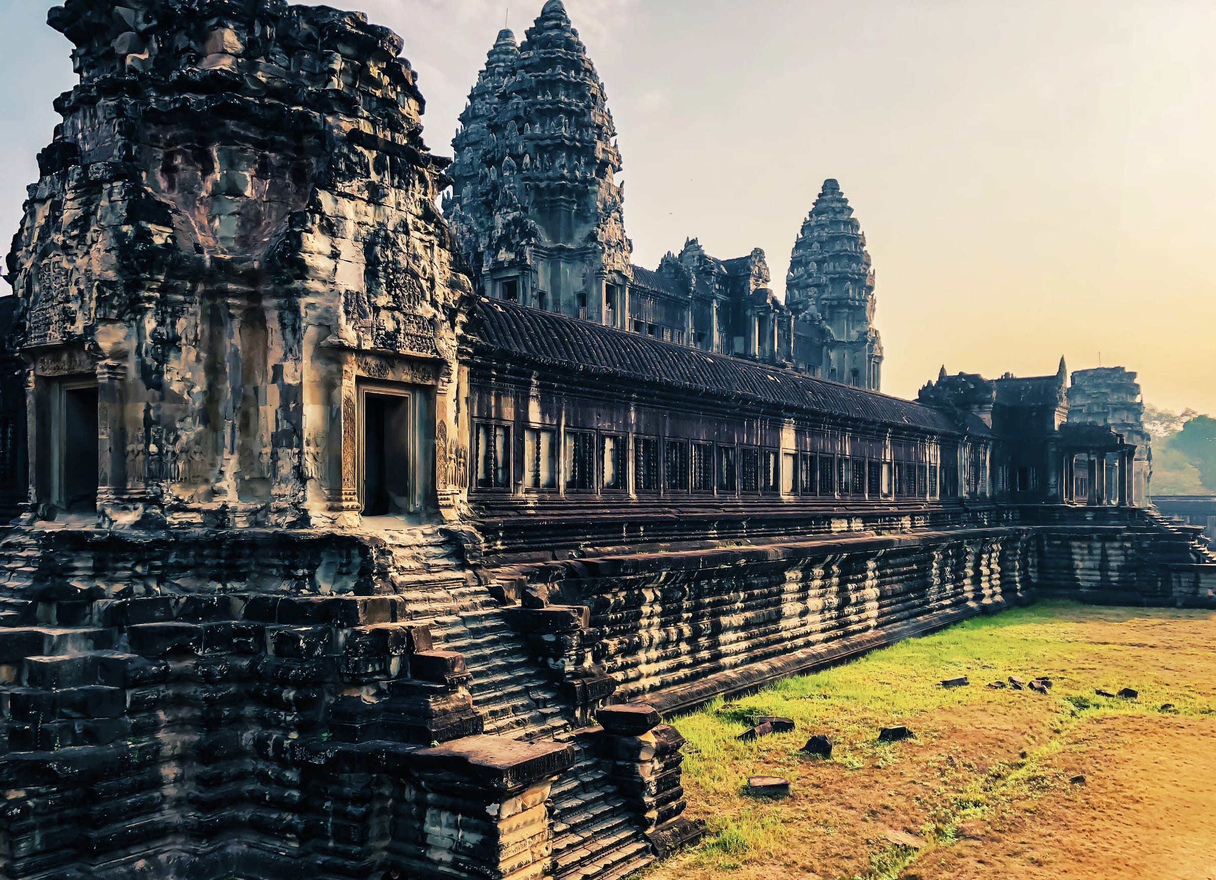 The outer gallery of Angkor Wat receding toward the towers at dawn
